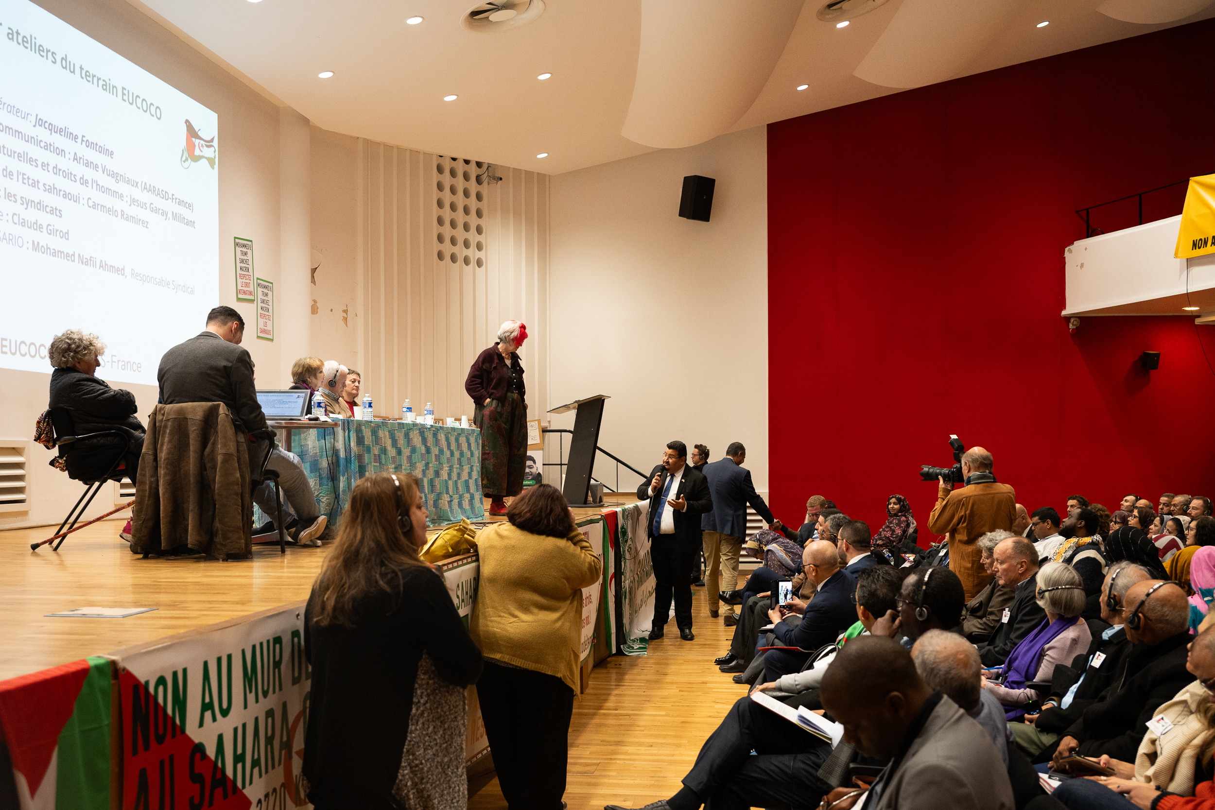 Audience gathered inside an auditorium.