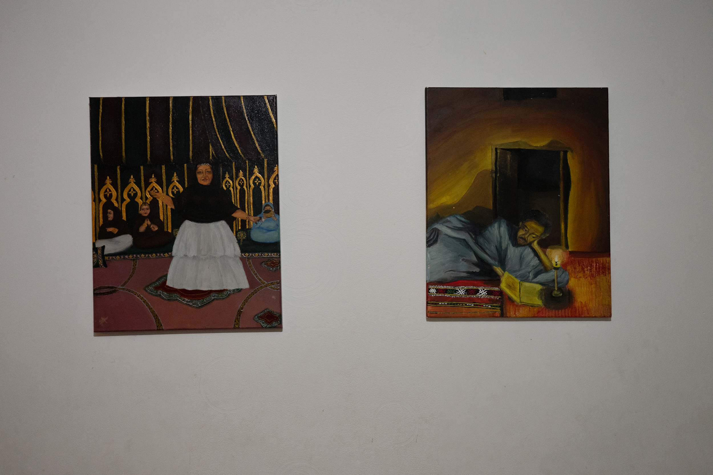 Two paintings displayed on a wall.