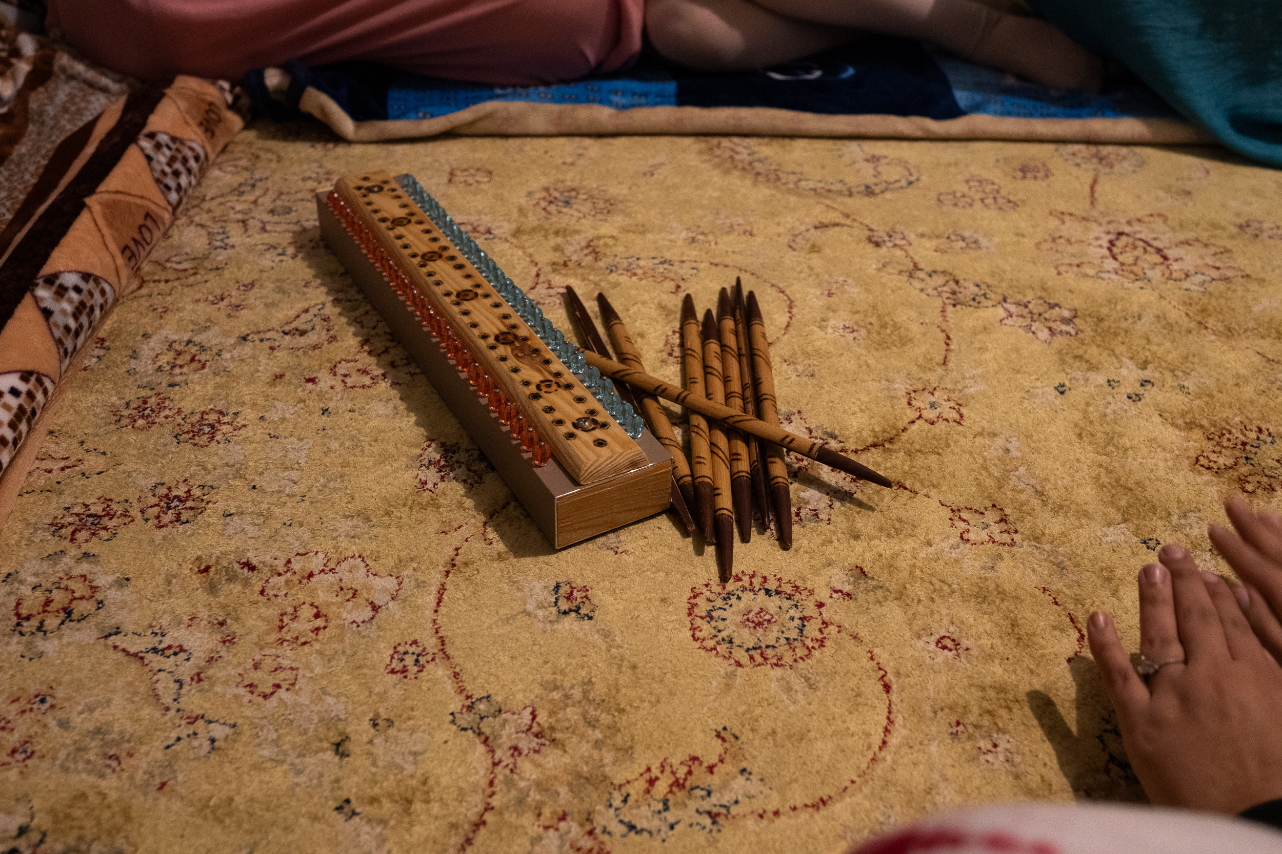 Musical instrument and wooden sticks on a carpet.