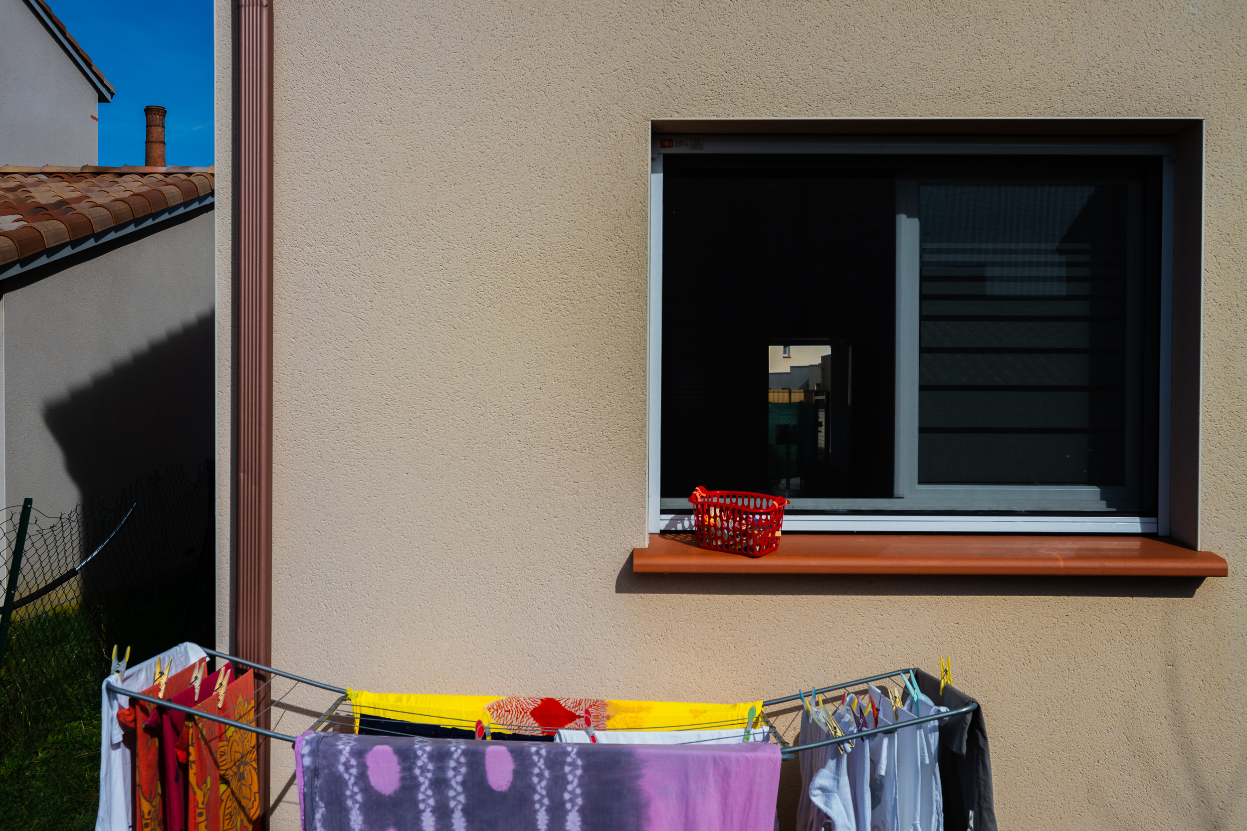 Window with laundry drying in the foreground.