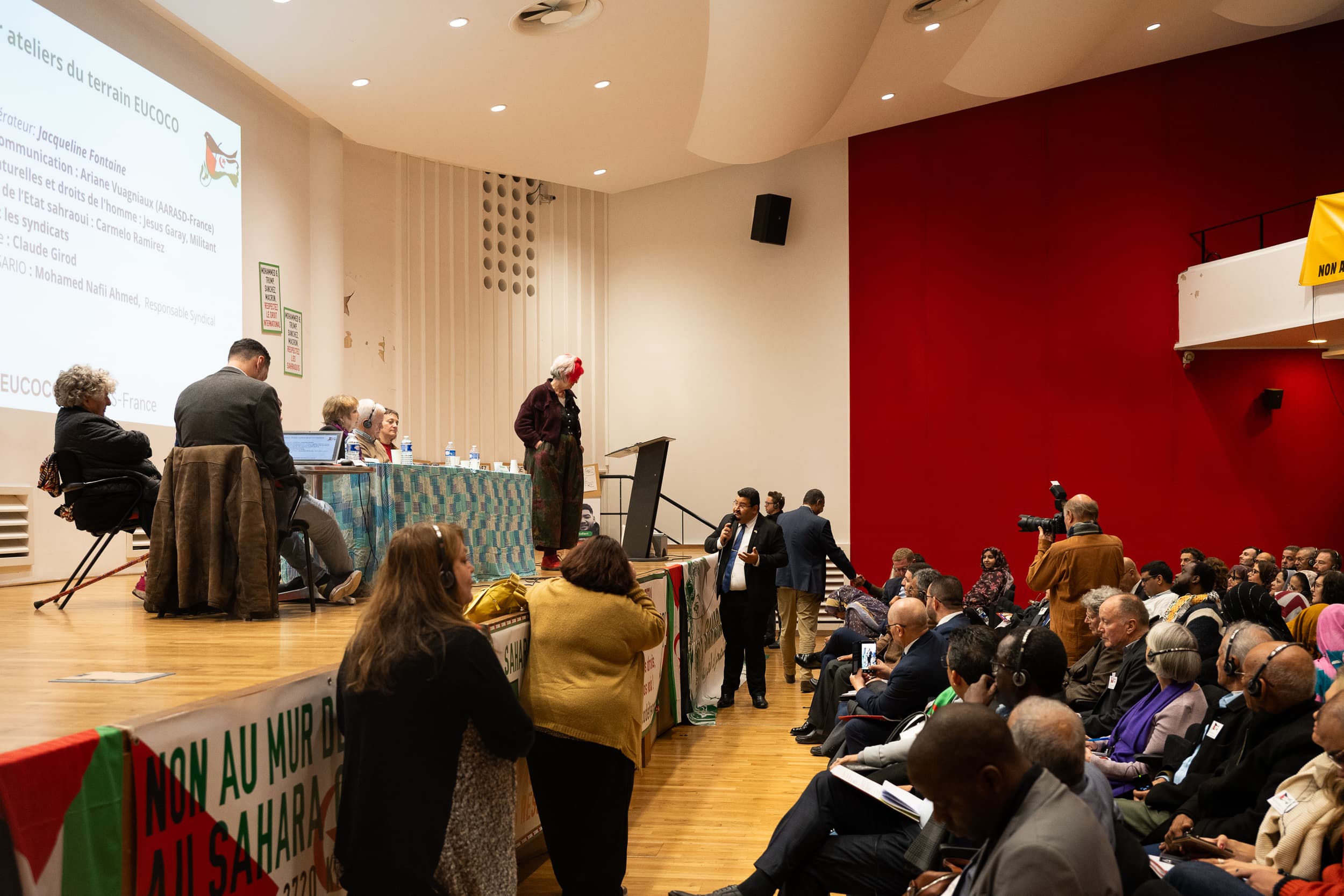 Audience gathered inside an auditorium.
